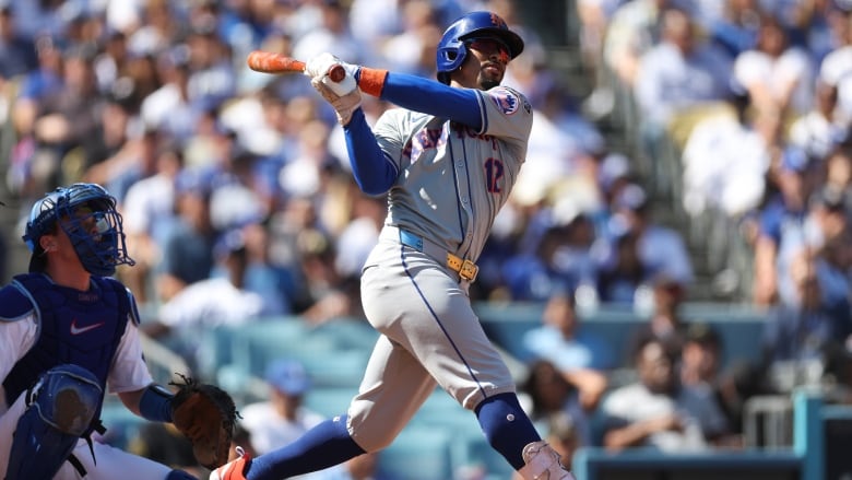 A male baseball player is seen hitting a ball during a game.