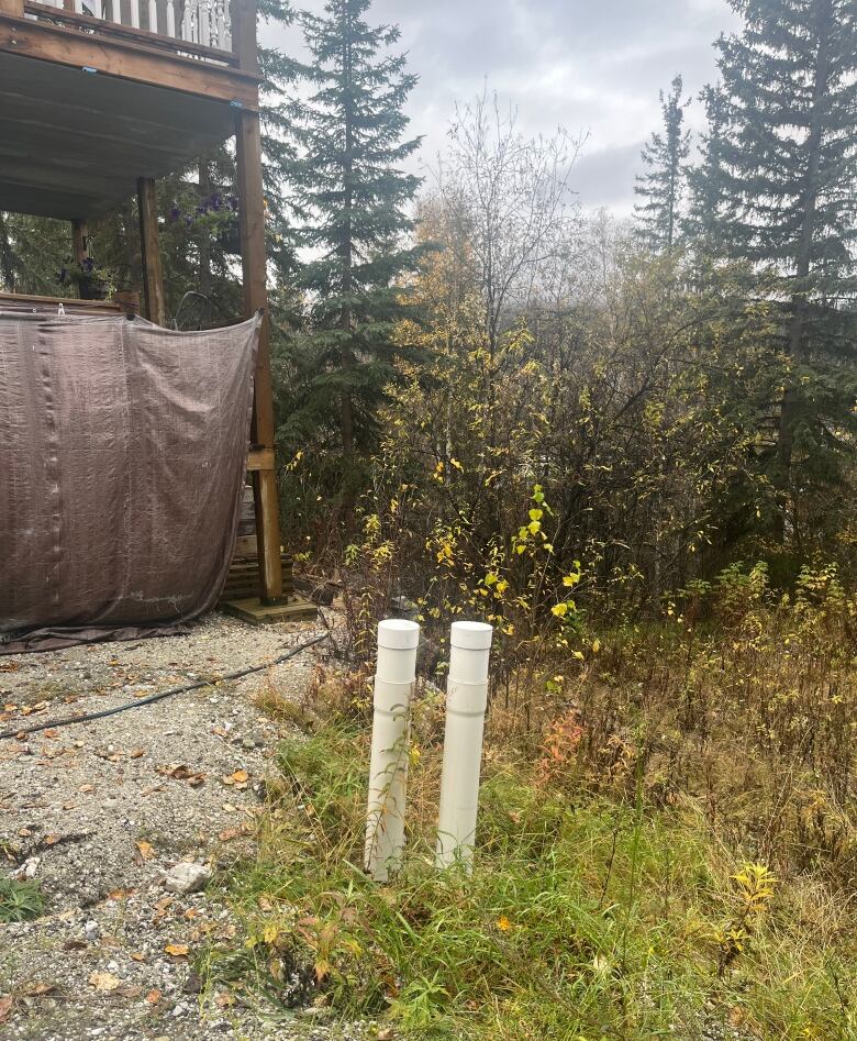 A picture of a deck, and a septic tank pump out tube.