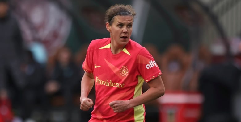 A woman in a red soccer jersey