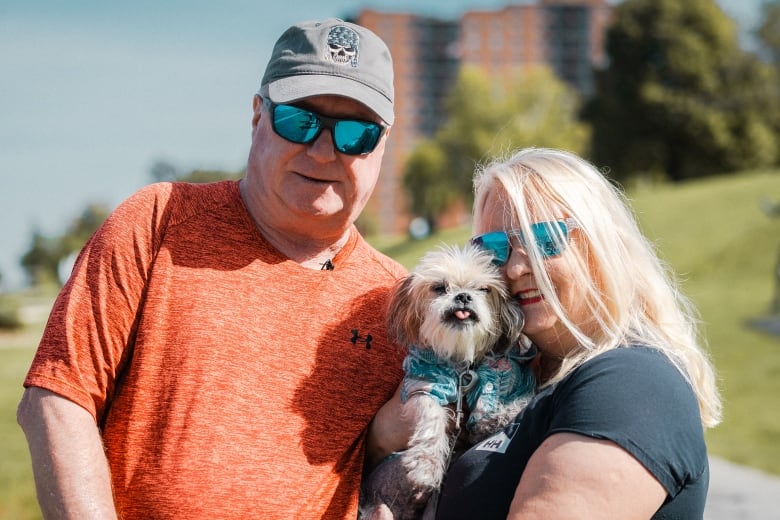 Peter and Debbie Wright pose with their pup Mickey. 