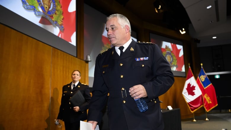 RCMP Commissioner Mike Duheme, centre, and Assistant Commissioner Brigitte Gauvin leave a press conference on Monday, Oct. 14, 2024 after accusing agents of the Indian government of playing a role in 'widespread violence' in Canada.