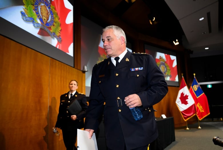 RCMP Commissioner Mike Duheme, centre, and Assistant Commissioner Brigitte Gauvin leave a press conference on Monday, Oct. 14, 2024 after accusing agents of the Indian government of playing a role in 'widespread violence' in Canada.