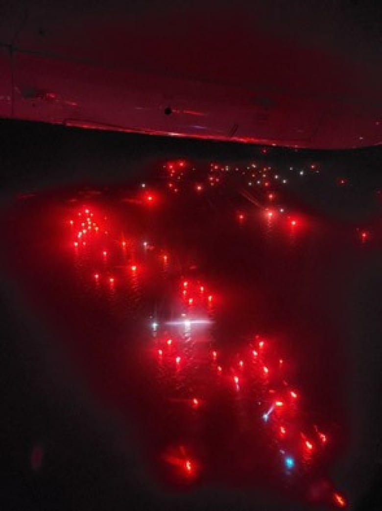 A carpet of red lights on a black sea at night.