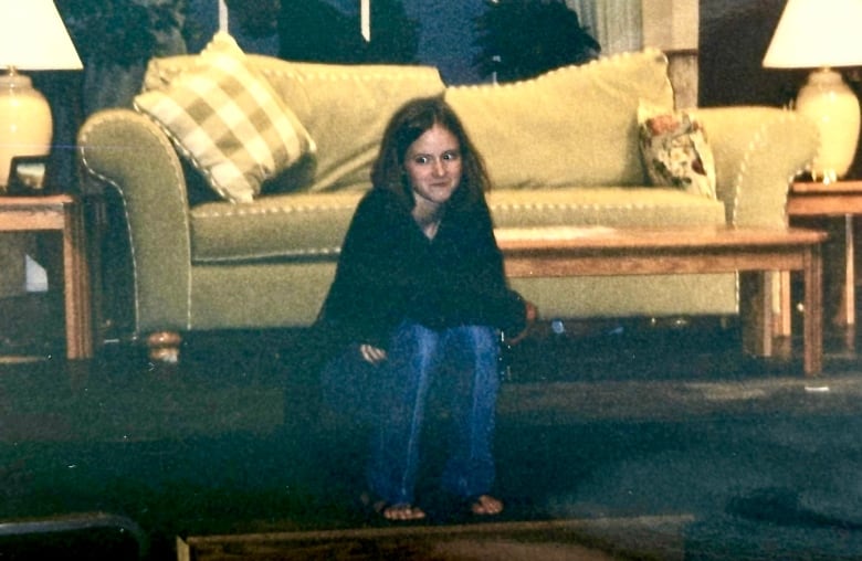 A person sits on a stage.