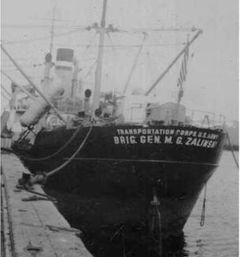 A black-and-white photo of a boat. 