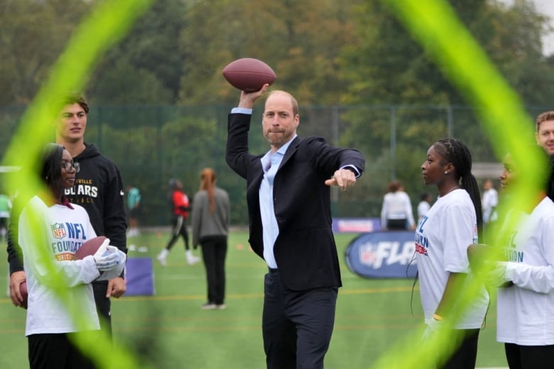 A person throws a football.