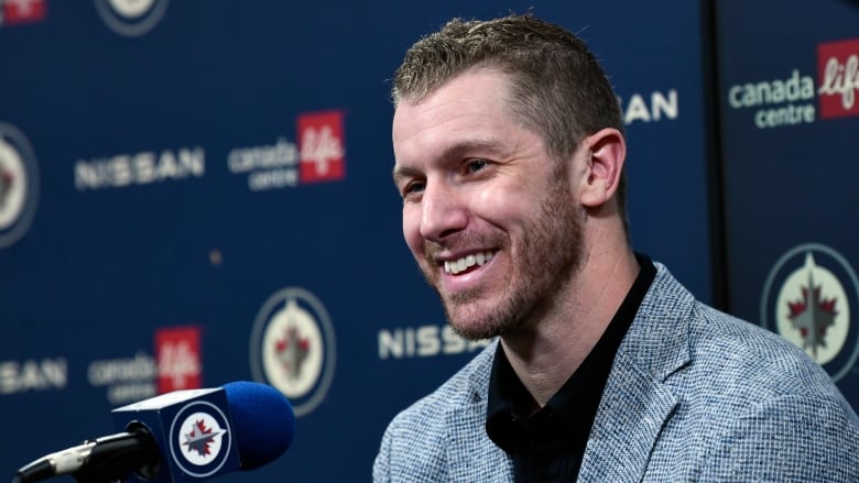 A hockey player smiles. 