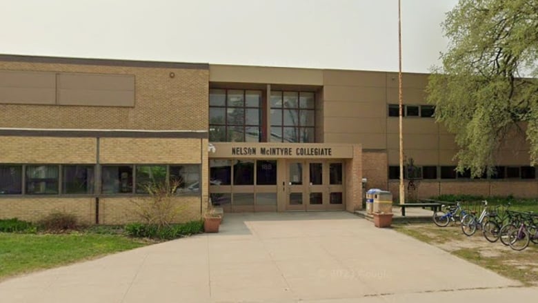 Exterior of a school and its front doors.