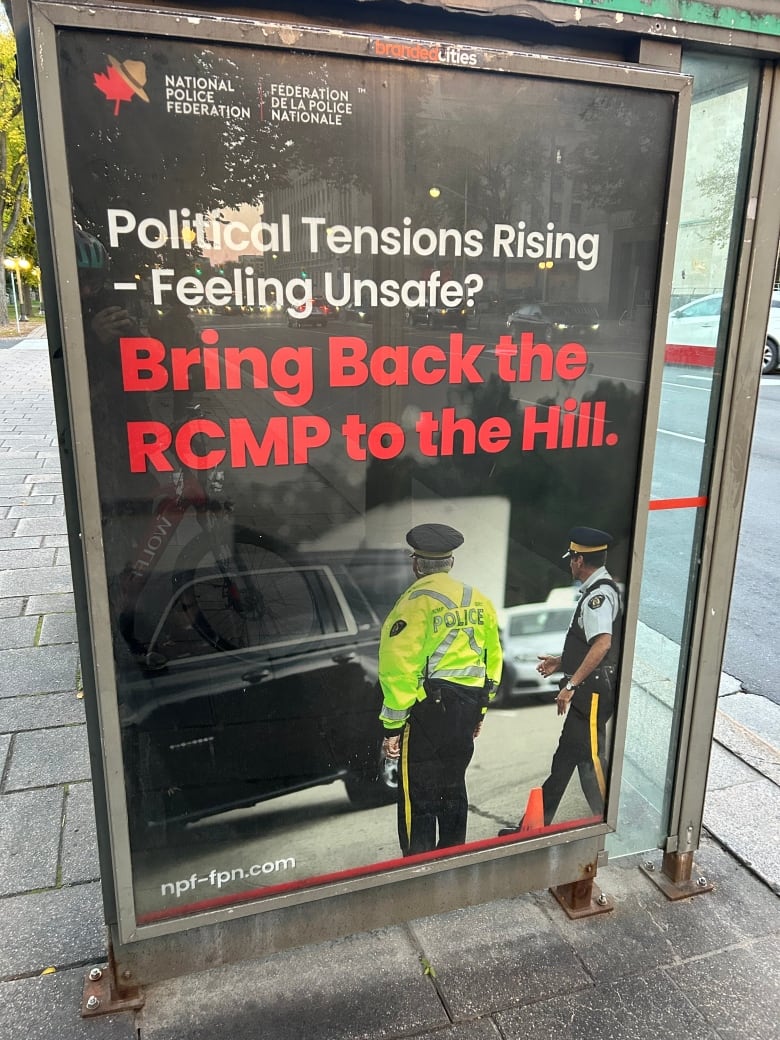 An RCMP poster at a bus shelter calls on politicians in Ottawa to 