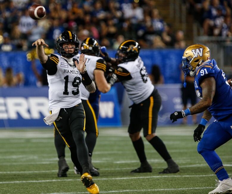 Hamilton Tiger-Cats quarterback Bo Levi Mitchell (19) makes a pass during second half CFL action against the Winnipeg Blue Bombers in Winnipeg Friday, August 23, 2024