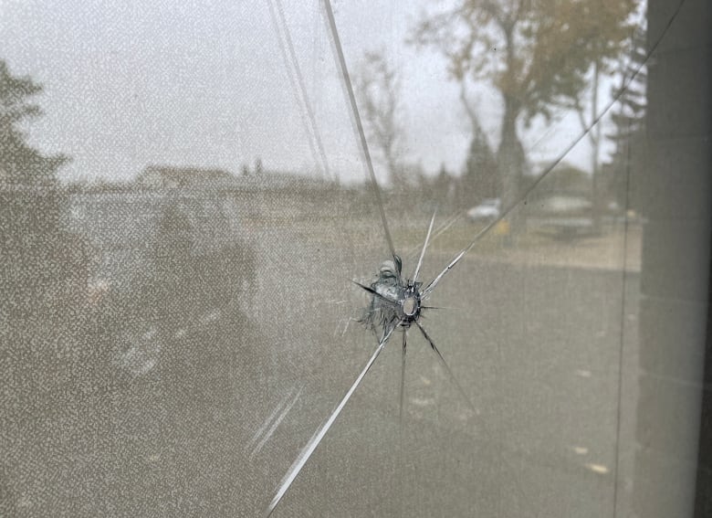 A hole in an office window.