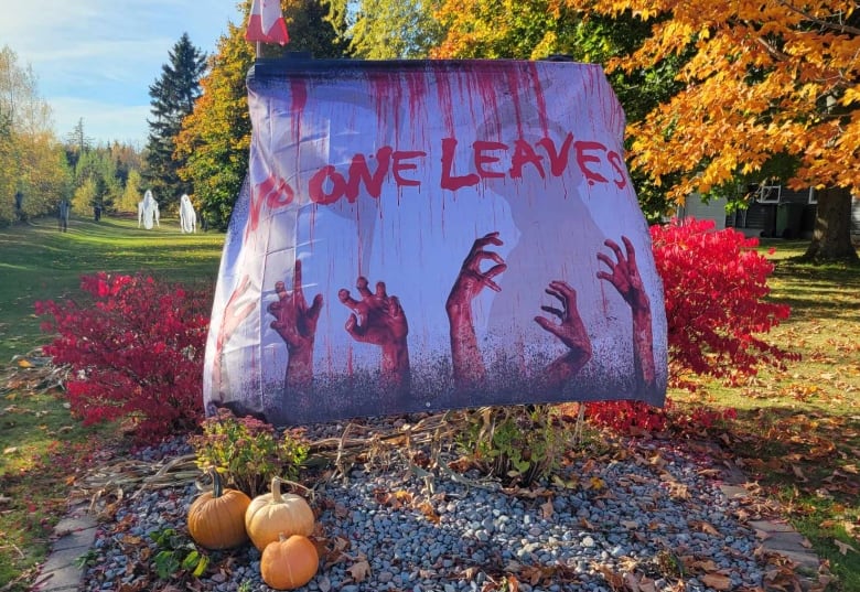 A large bag presumably full of leaves that says 'No One Leaves' in large, bloody dripping letters.