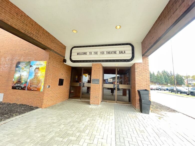 A brick building with the words WELCOME TO THE YES THEATRE GALA