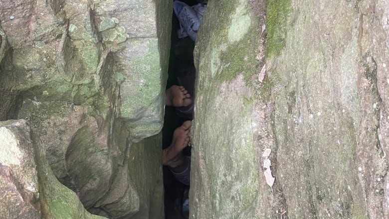 A pair of feet in a crevice