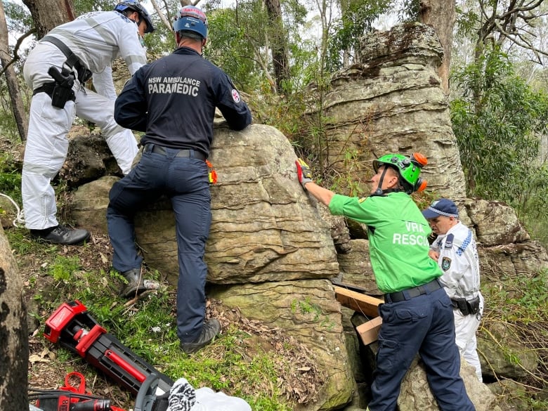 Rescuers  on  a  rocky outcropping