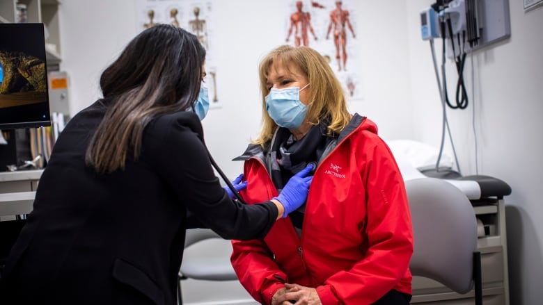 A nurse practitioner with a patient at a clinic.