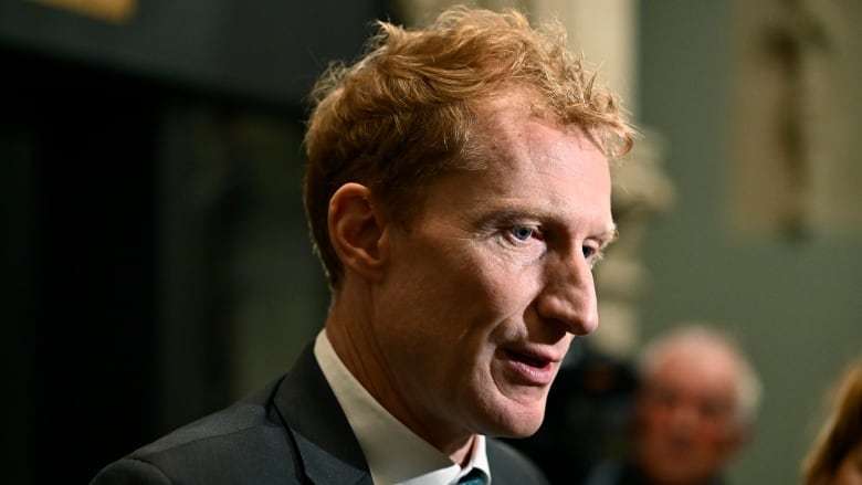 Minister of Immigration, Refugees and Citizenship Marc Miller takes questions from reporters as the Liberal caucus meets on Parliament Hill in Ottawa on Wednesday, Oct. 9, 2024.