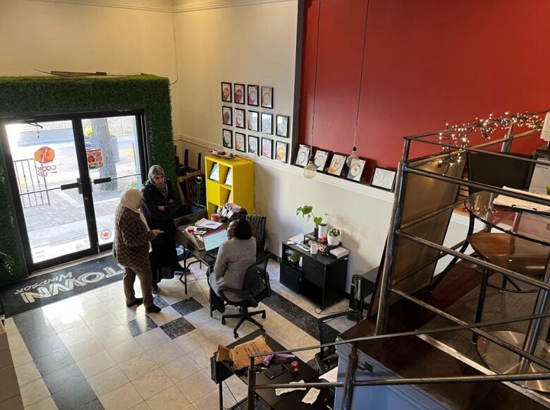 Linton speaks with two food entrepreneurs at the nonprofit storefront in downtown Windsor, Ont.