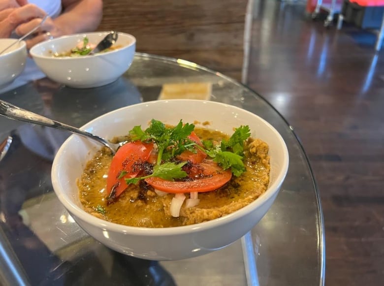 A garlic bean dish is served at Cook Up, prepared at the shared kitchen by chef Adam Khassim, owner of Zinza Garlic Sauce Company. 