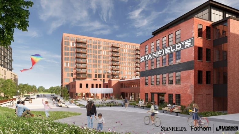 A computer image shows a four-storey red brick building with a black painted banner reading Stanfield's across the front. There are higher-rise buildings to the far left, and people walk and bike down a street in front of the building