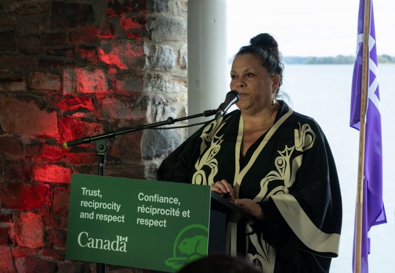 a woman speaking at a podium.