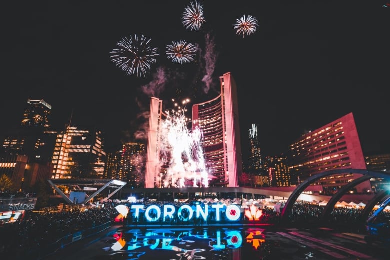 Fireworks exploding above Toronto city hall at Nathan Phillips Square