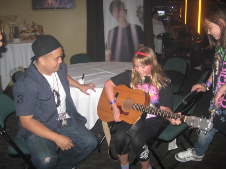 A girl is playing the guitar.