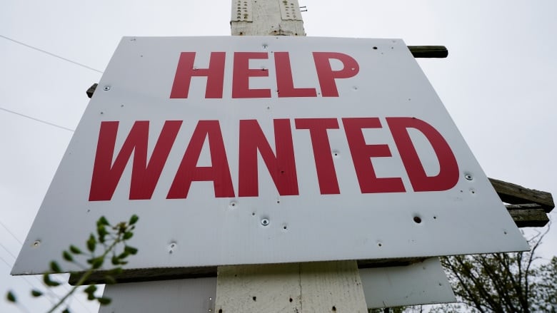 a sign reads 'help wanted'