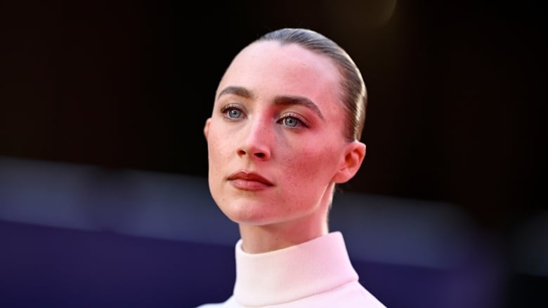 An actress is pictured in a white dress