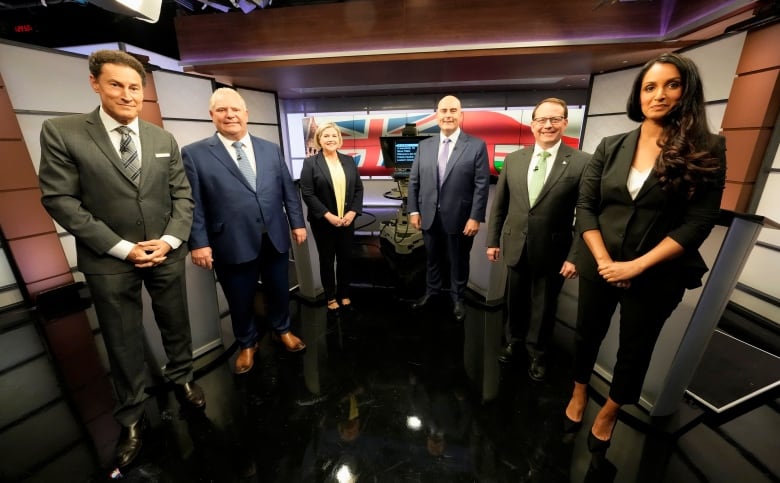 Hosts Steve Paikin, left, and Althia Raj, right, pose for a photo with Ontario Progressive Conservative Party Leader Doug Ford, left to right, Ontario New Democratic Party Leader Andrea Horwath, Ontario Liberal Party Leader Steven Del Duca and Green Party of Ontario Leader Mike Schreiner ahead of the Ontario party leaders' debate, in Toronto, Monday, May 16, 2022.