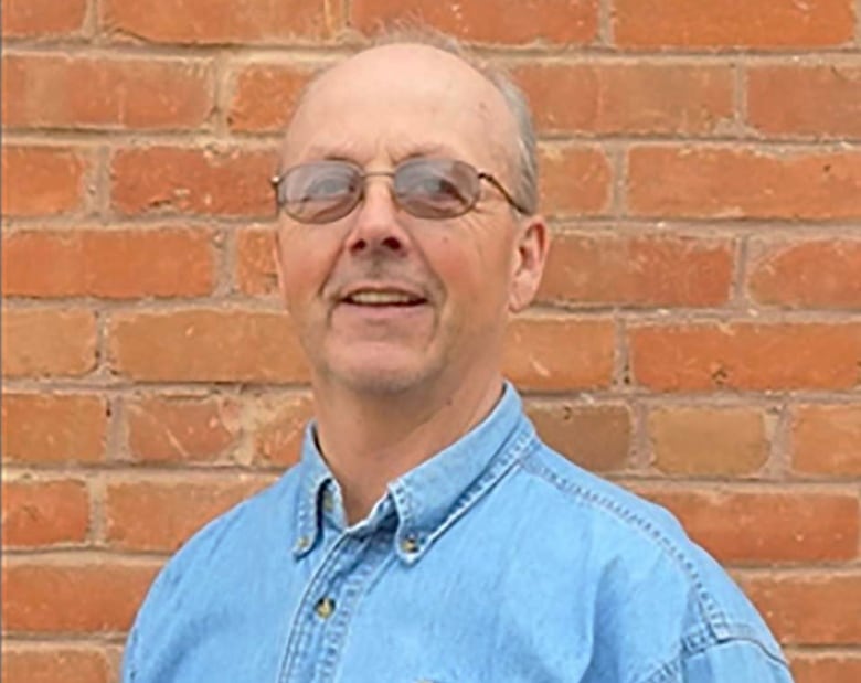 man posing against wall