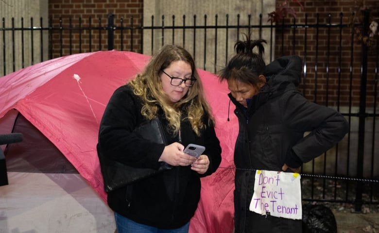 Two women in front of a tent