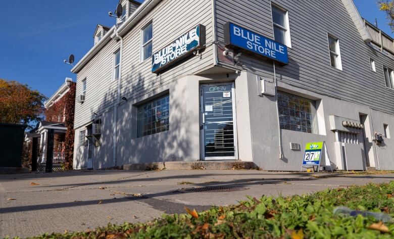 A convenience store's blue sign that says Blue Nile Store.