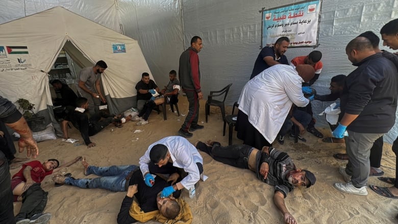 Wounded men lay on the floor at a makeshift hospital.