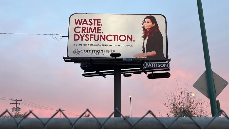 A billboard is shown at sunset. The billboard features the words 