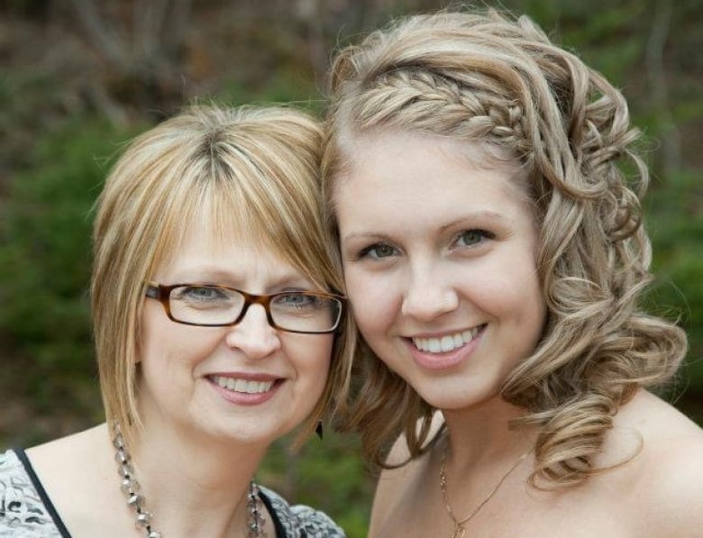 two women in dresses smiling