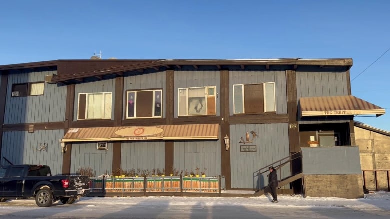 The outside of a 2-storey building on a snowy day.