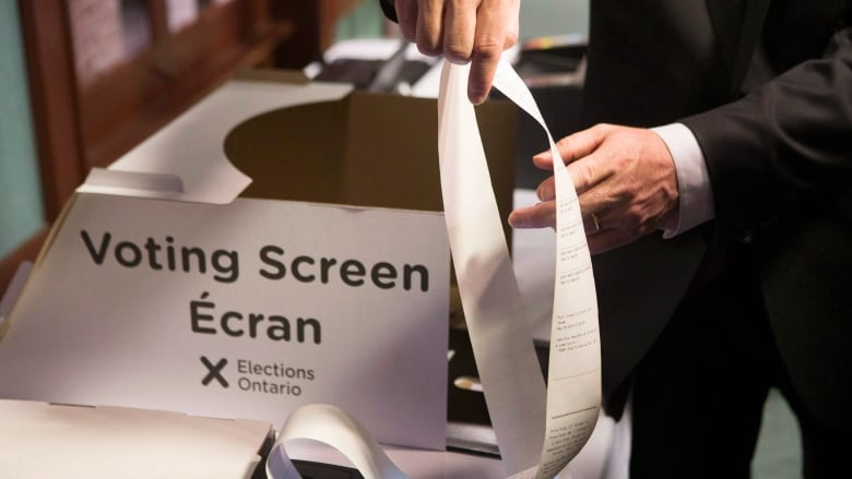 Ontario's Chief Electoral Officer Greg Essensa demonstrates an electronic voting machine during a media availability in Toronto on Wednesday, May 9 , 2018. The rise of artificial intelligence and its ability to rapidly spread misinformation and disinformation during election campaigns should be addressed by increasing transparency around political ads and allowing for the removal of misleading content about the electoral process, Essensa recommends.THE CANADIAN PRESS/Chris Young