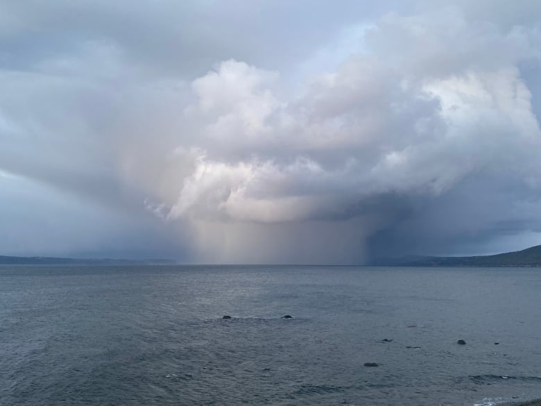 Clouds look worrisome over the ocean.