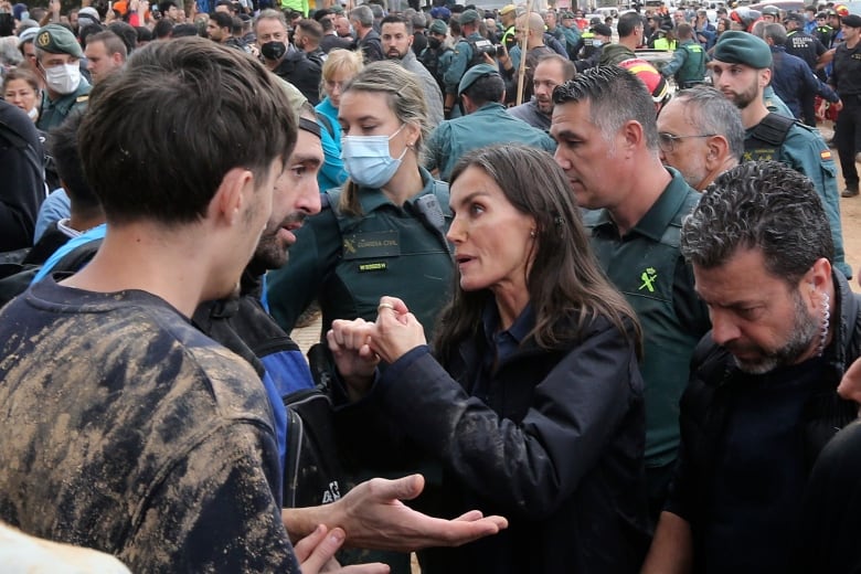 Spain's Queen Letizia speaks with people.