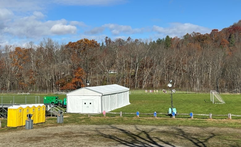 A makeshift building is seen in a soccer field.