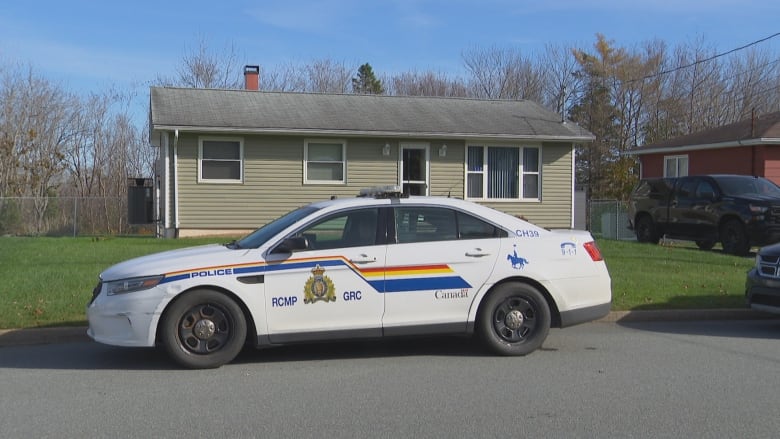 police vehicle parked in front of a home