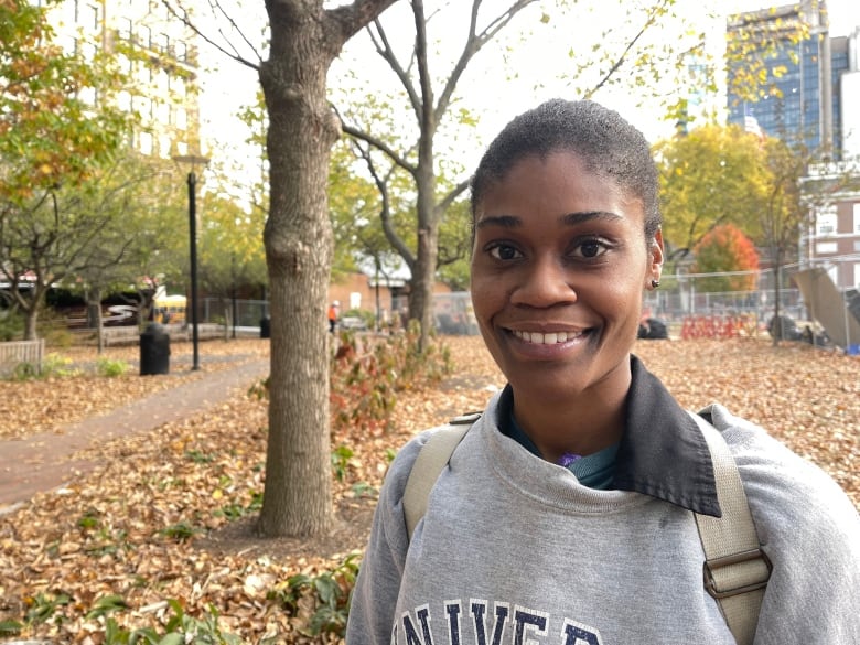 A woman in a grey crewneck.