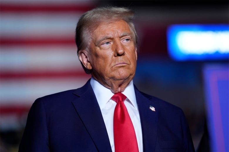 Former U.S. president Donald Trump listens during a campaign rally in Reading, Pa.