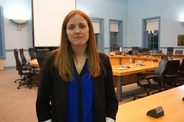 A woman standing in a conference room