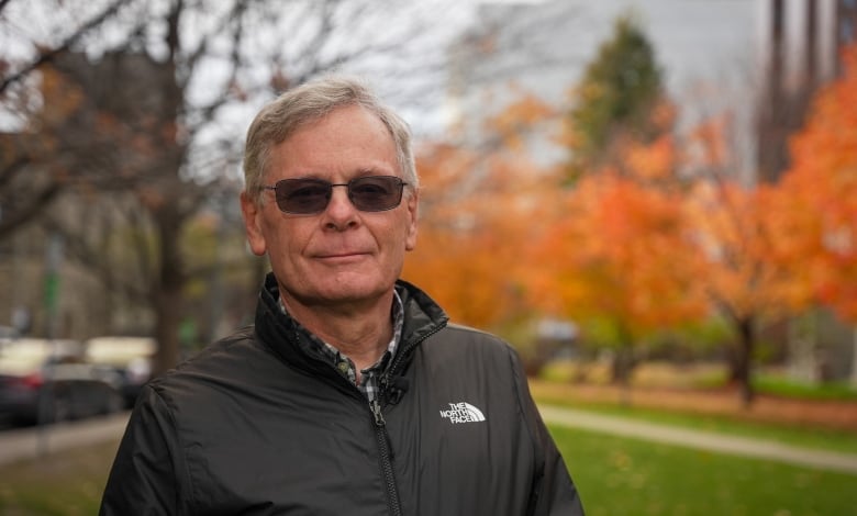 A city manager outside city hall in the fall.