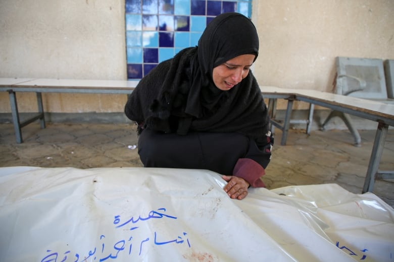 A mourner reacts next to the bodies of Palestinians killed in Israeli strikes, amid the Israel-Hamas conflict, in Khan Younis in the southern Gaza Strip November 6, 2024. 