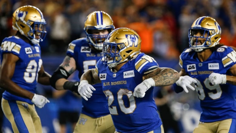 Men's football players celebrate during a game.