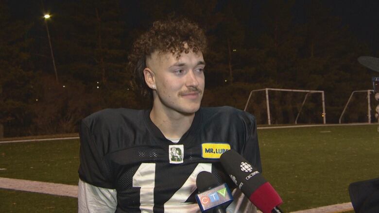 Man in football jersey.