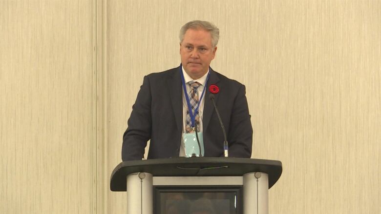 A man stands at a podium.